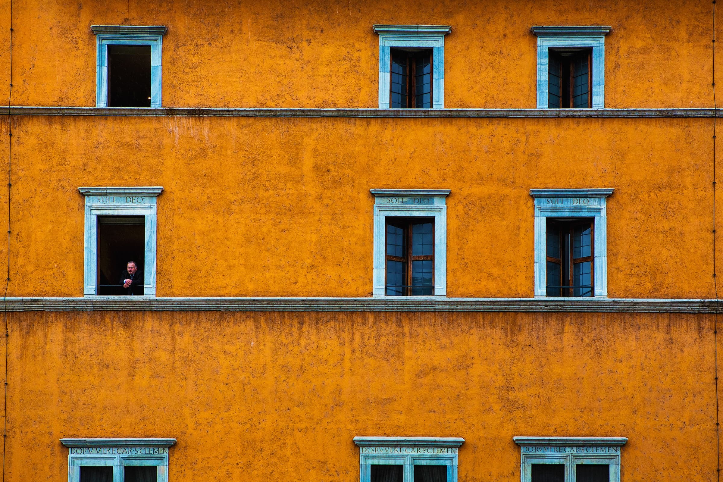 Orange building with a figure in the window