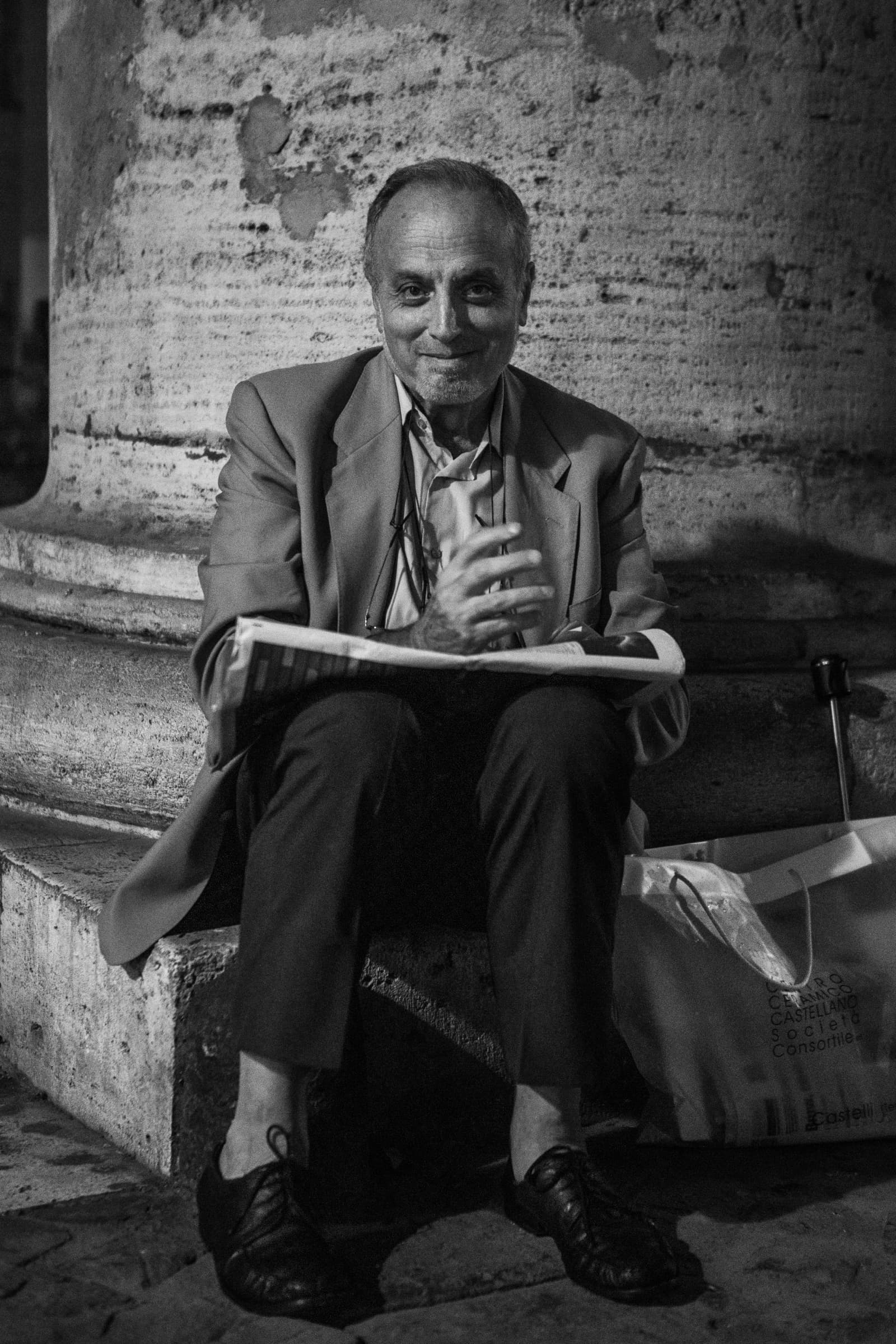 Man seated beside a column